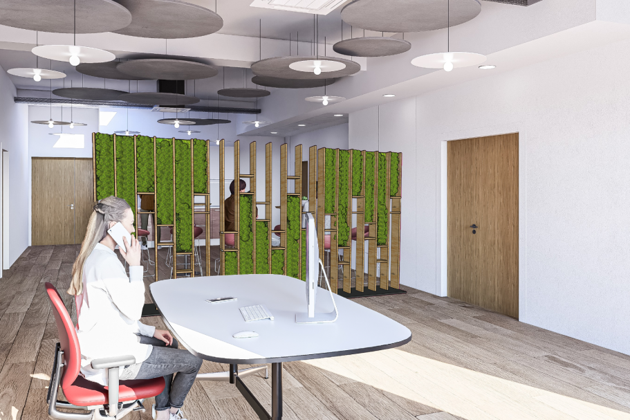 Bureau moderne avec une personne assise, séparations végétales et éclairage ample.